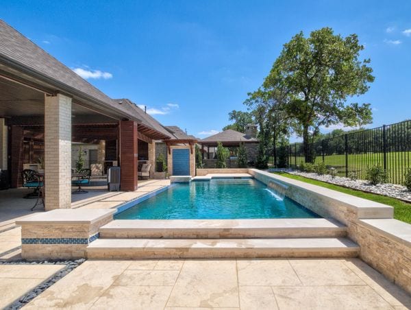 A gorgeous picture of a rectangular pool.