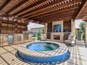 round spa under a wooden pergola