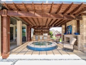 a round spa under a wooden pergola