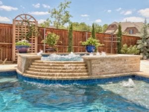 A gorgeous spa connected to a swimming pool. 